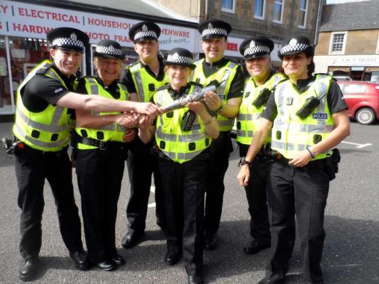 Photograph of Bobbies And The Queen's Baton At Thurso
