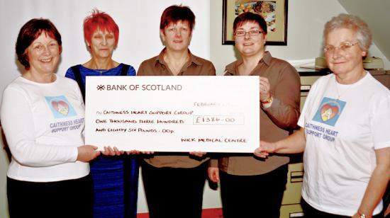 Photograph of Wick Medical Centre Staff Present Cheque To Caithness Heart Support