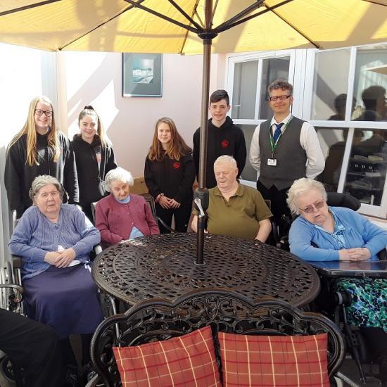 Photograph of High School pupils furnish garden comfort for Bayview Care Home